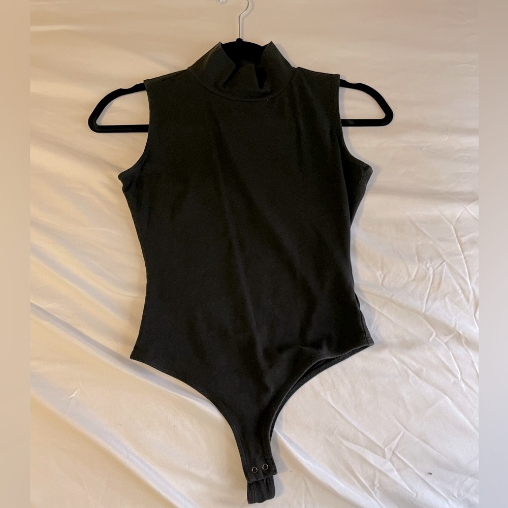 Black thong style turtle neck sleeveless body suit
